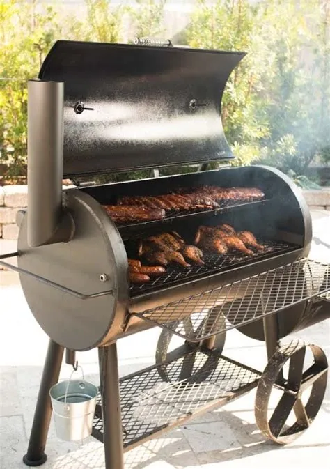 A man and woman standing next to an outdoor grill.